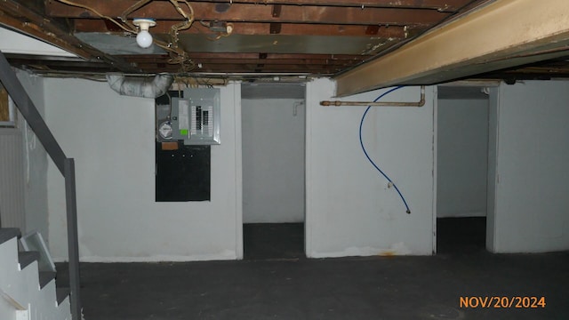 unfinished basement with stairway and electric panel