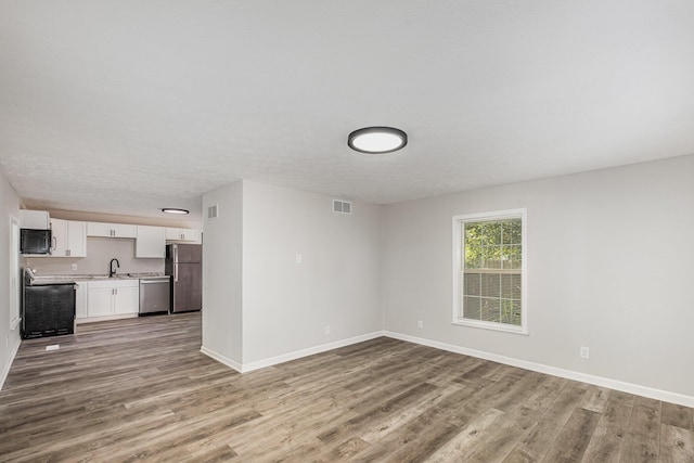 29 Race St, Dry Ridge, KY 41035 - unfurnished living room featuring wood finished floors and baseboards