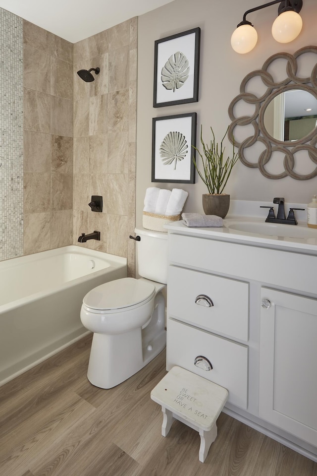 full bathroom featuring shower / washtub combination, toilet, vanity, and wood finished floors