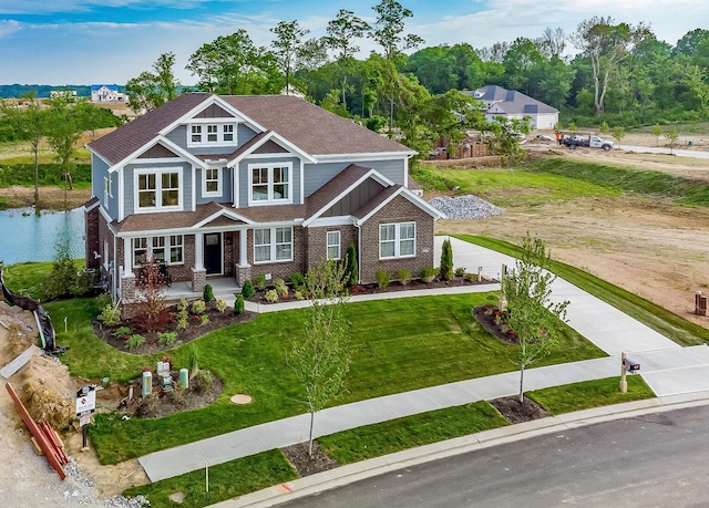 view of front of home with a front lawn and brick siding