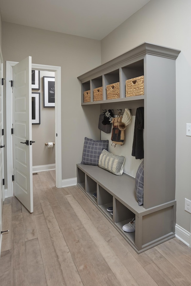 mudroom with baseboards and wood finished floors