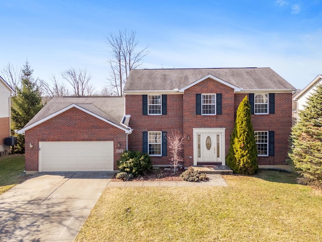 colonial-style house with a front yard, an attached garage, brick siding, and driveway