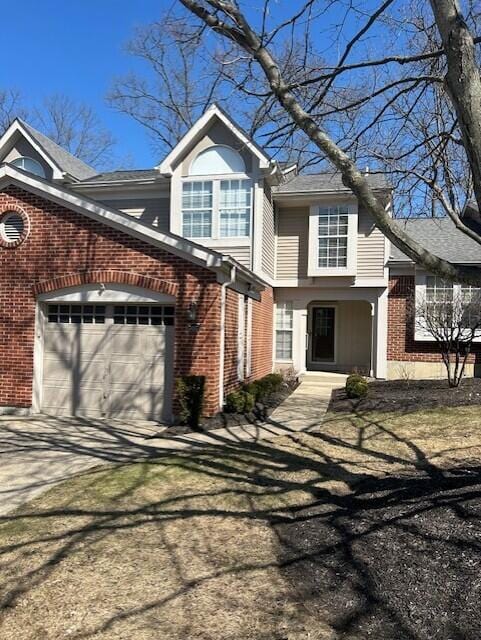 view of front facade featuring a garage, brick siding, concrete driveway, and a chimney