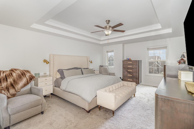 bedroom with light carpet, multiple windows, a raised ceiling, and ornamental molding