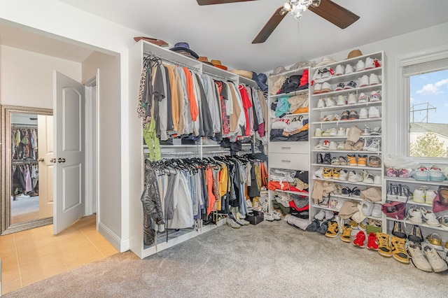 walk in closet featuring carpet, a ceiling fan, and tile patterned flooring