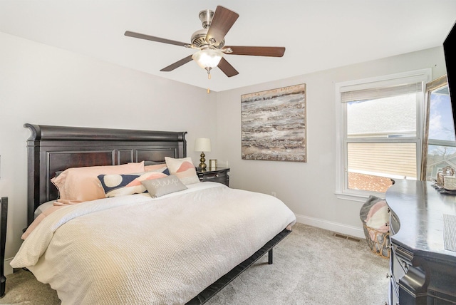 carpeted bedroom featuring visible vents, baseboards, and ceiling fan