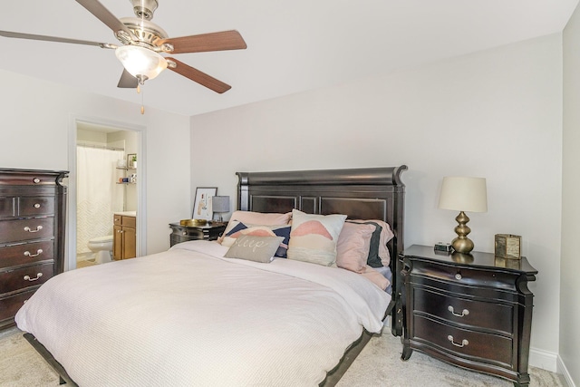 carpeted bedroom featuring connected bathroom and ceiling fan