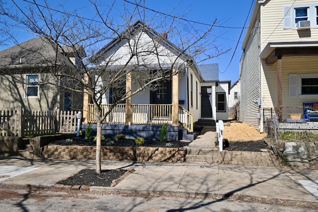 view of front of home with covered porch and fence