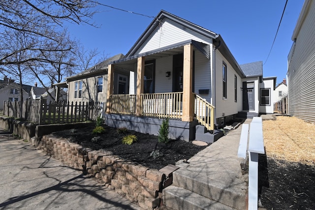 view of front of house with a porch and fence