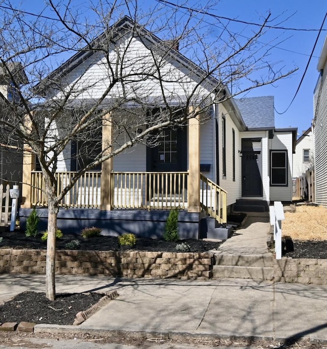 view of front of property featuring a porch and a shingled roof