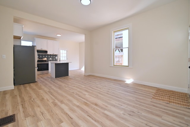 kitchen with visible vents, tasteful backsplash, appliances with stainless steel finishes, white cabinets, and light countertops