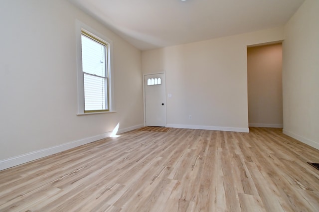 empty room with light wood-style floors and baseboards