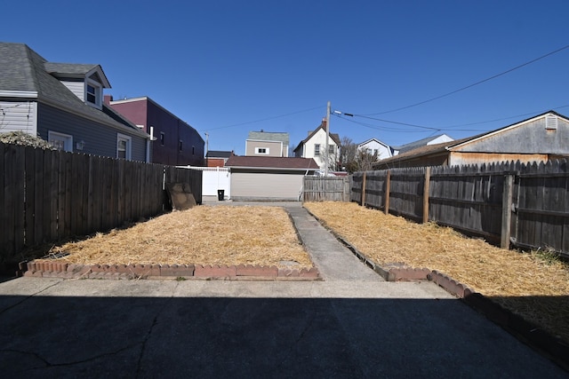 view of yard with an outbuilding and a fenced backyard