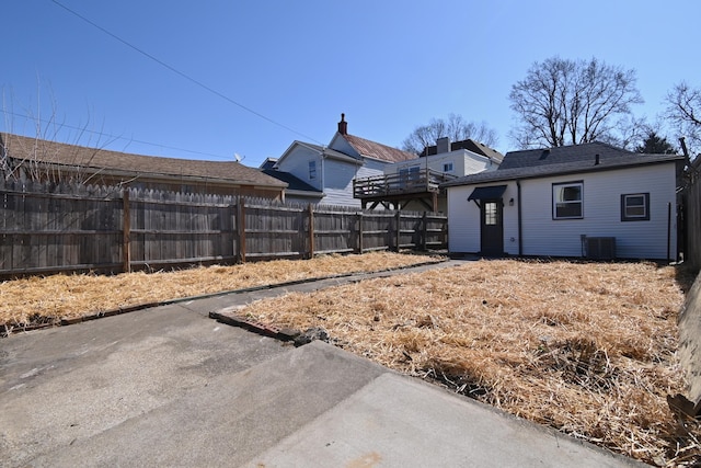 view of yard featuring central AC unit and fence private yard