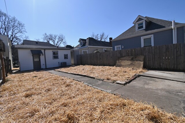 view of yard with central AC unit and fence