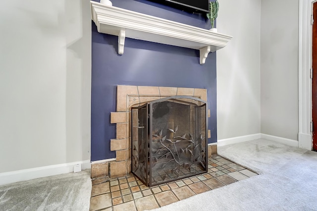 details with baseboards, carpet, and a tile fireplace