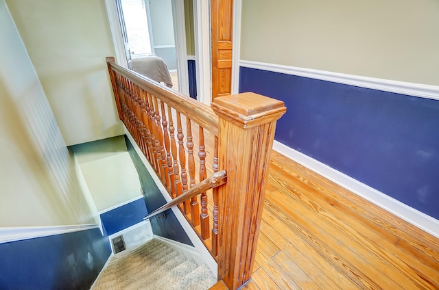 stairs featuring wood finished floors and baseboards