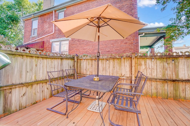 wooden deck featuring outdoor dining space and fence