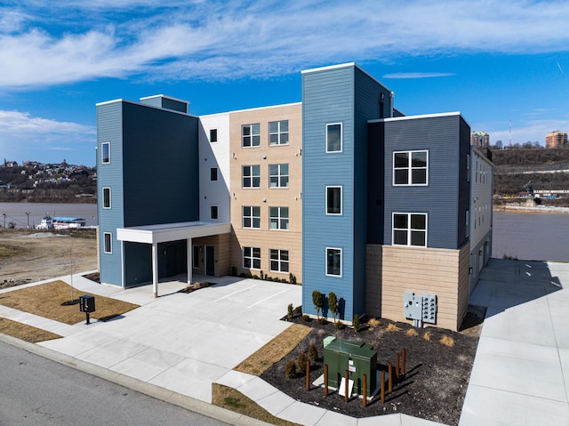 view of building exterior featuring concrete driveway