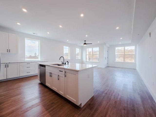 kitchen with stainless steel dishwasher, recessed lighting, dark wood finished floors, and a sink