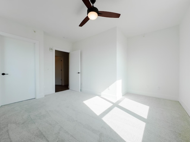 unfurnished bedroom with baseboards, a ceiling fan, and carpet flooring