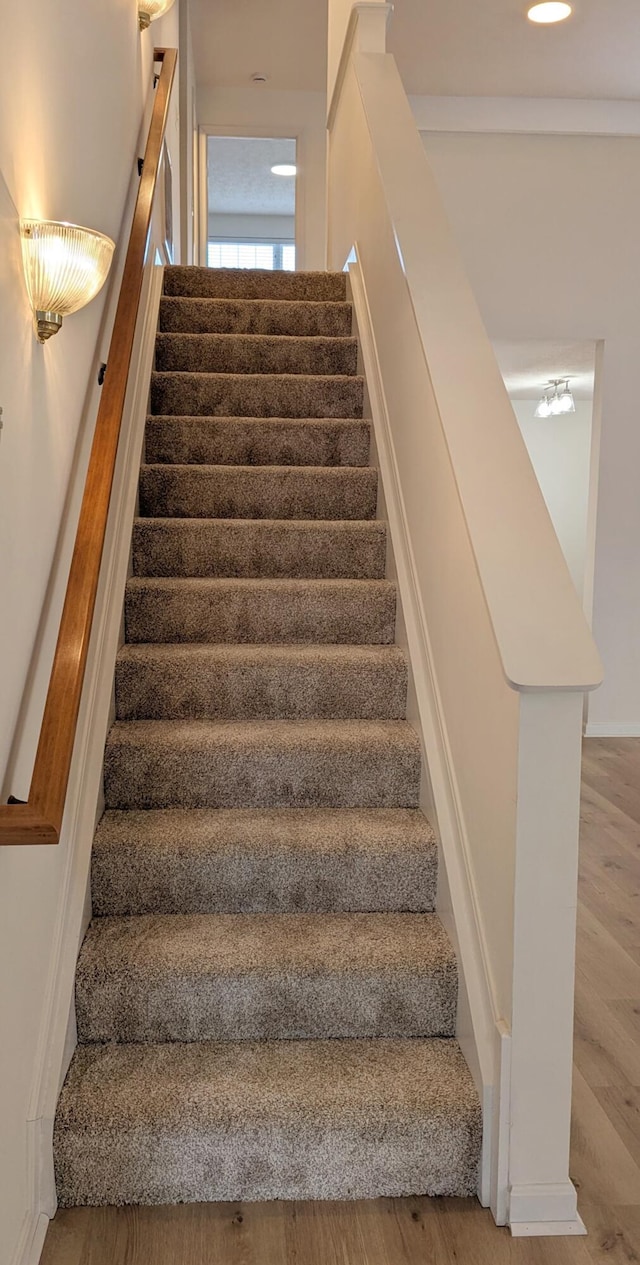 staircase featuring wood finished floors