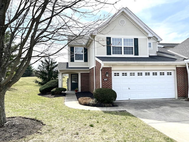 traditional home with brick siding, a shingled roof, a front yard, a garage, and driveway