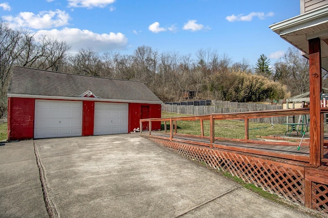 detached garage featuring fence