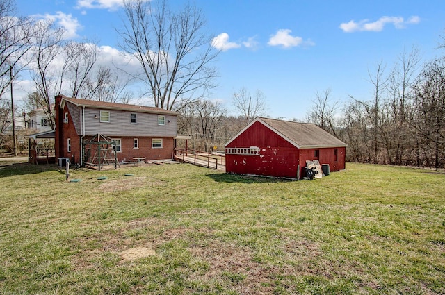 view of yard featuring an outbuilding, central AC unit, and fence