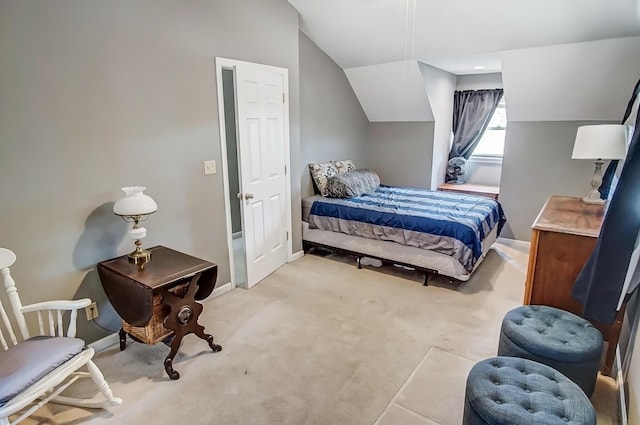 bedroom featuring vaulted ceiling, light colored carpet, and baseboards