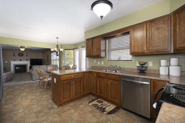 kitchen featuring black range with electric stovetop, dishwasher, a peninsula, a glass covered fireplace, and a sink