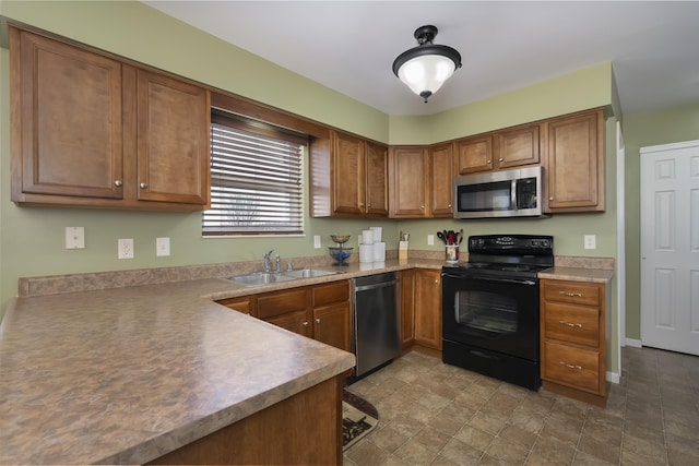 kitchen with brown cabinetry, appliances with stainless steel finishes, light countertops, and a sink