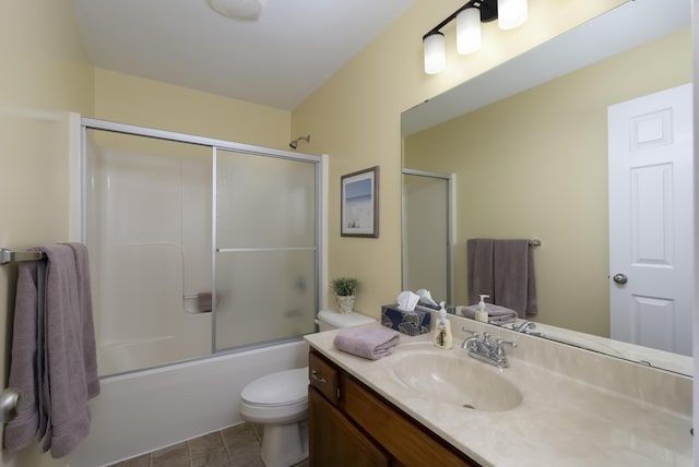 bathroom featuring bath / shower combo with glass door, toilet, and vanity