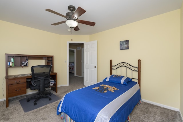 bedroom with a ceiling fan, baseboards, and carpet floors