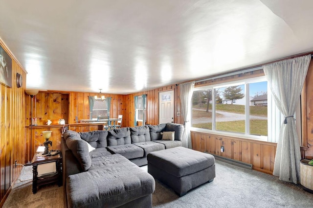 carpeted living area with wood walls