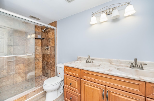 full bathroom with a stall shower, toilet, visible vents, and a sink