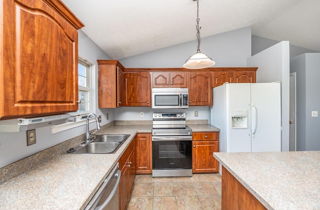 kitchen with lofted ceiling, light countertops, appliances with stainless steel finishes, and a sink