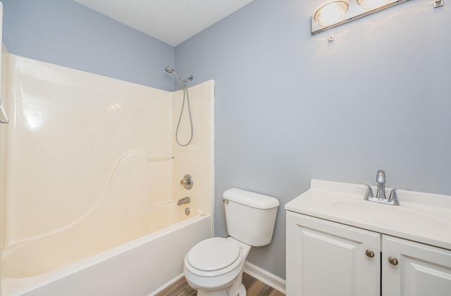 full bath with toilet, wood finished floors, tub / shower combination, baseboards, and vanity