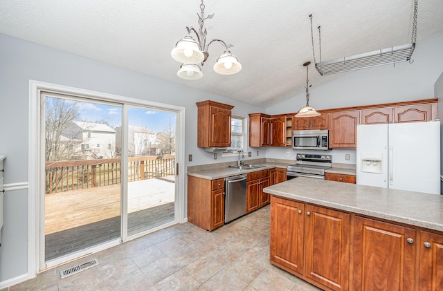 kitchen featuring visible vents, a notable chandelier, a sink, stainless steel appliances, and light countertops