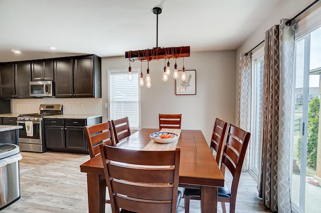 dining room featuring recessed lighting, an inviting chandelier, and light wood-style floors