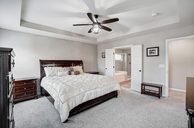 bedroom with baseboards, a raised ceiling, carpet, and a ceiling fan