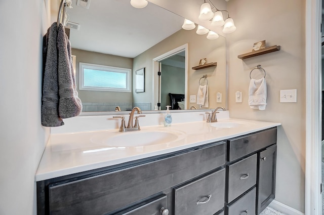 full bath featuring double vanity, visible vents, and a sink