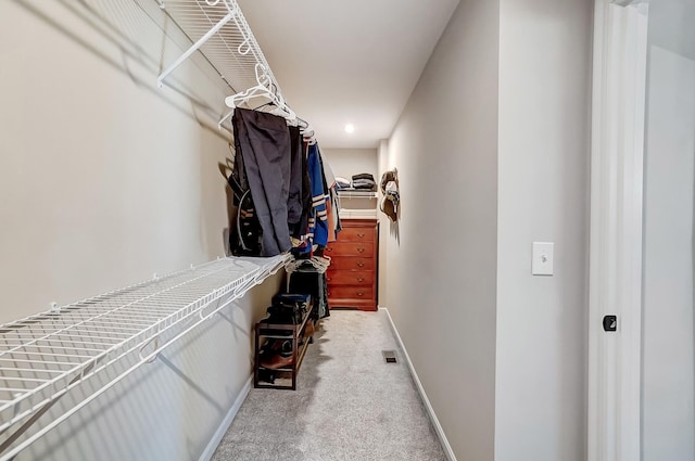 spacious closet featuring visible vents and carpet