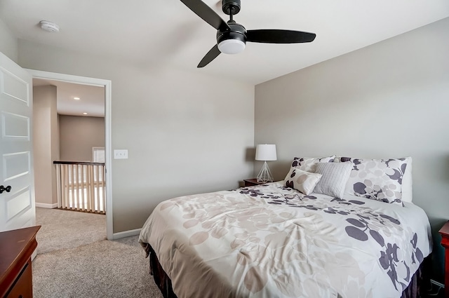 carpeted bedroom featuring a ceiling fan and baseboards