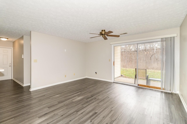 empty room with a textured ceiling, visible vents, dark wood-style flooring, and ceiling fan