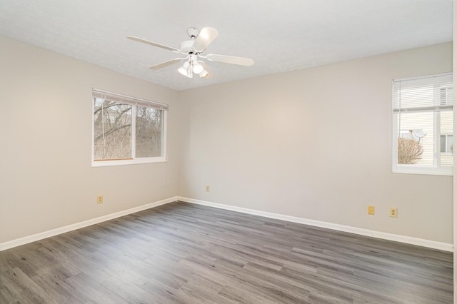 spare room featuring ceiling fan, baseboards, and wood finished floors