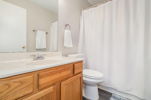 bathroom featuring toilet and vanity