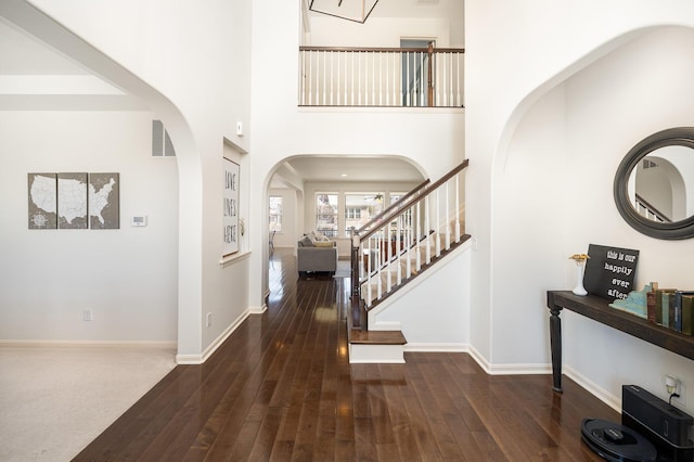 entryway featuring visible vents, baseboards, and hardwood / wood-style floors