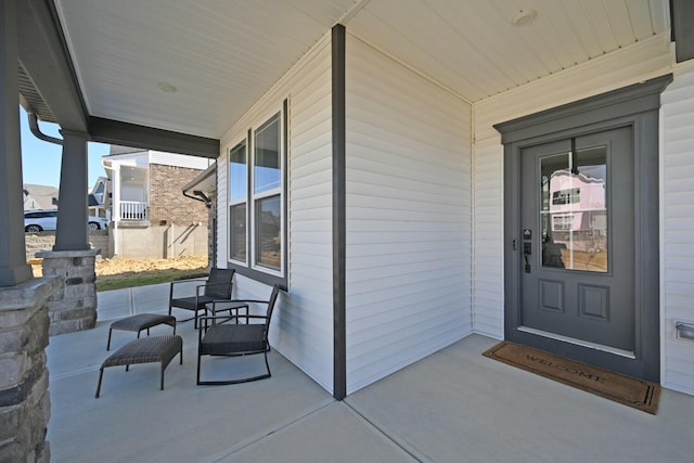 view of exterior entry with a porch