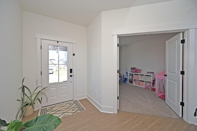 foyer entrance with light wood-type flooring and baseboards